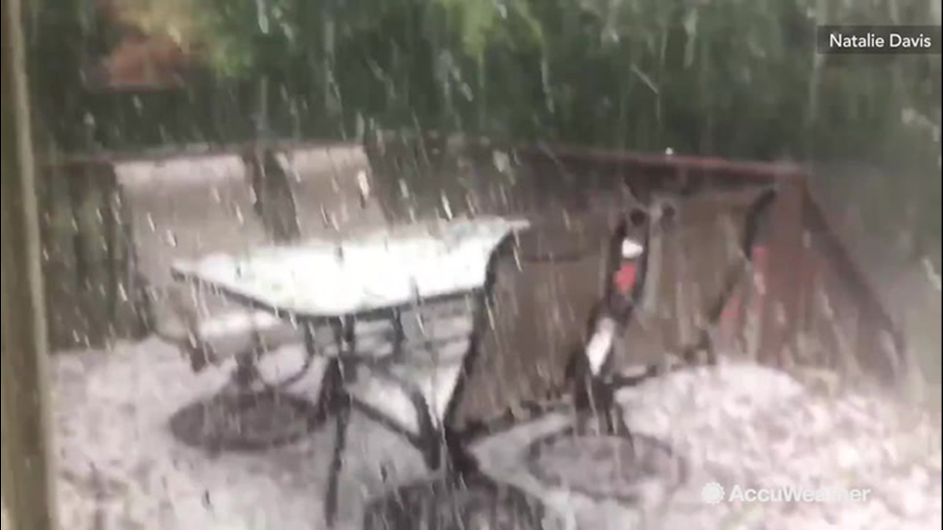 A storm pelted Wichita, Kansas with hail on June 18 that covered this patio as a dog watches from inside.