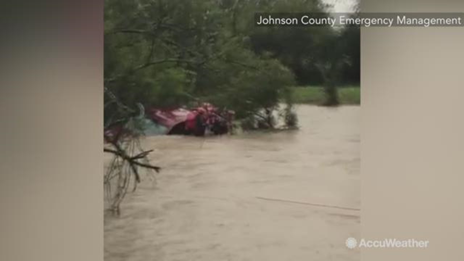 Emergency management officials in Johnson County, Texas, said fire crews rescued a person from the roof of a car that was submerged by floodwaters on Monday, October 15.
