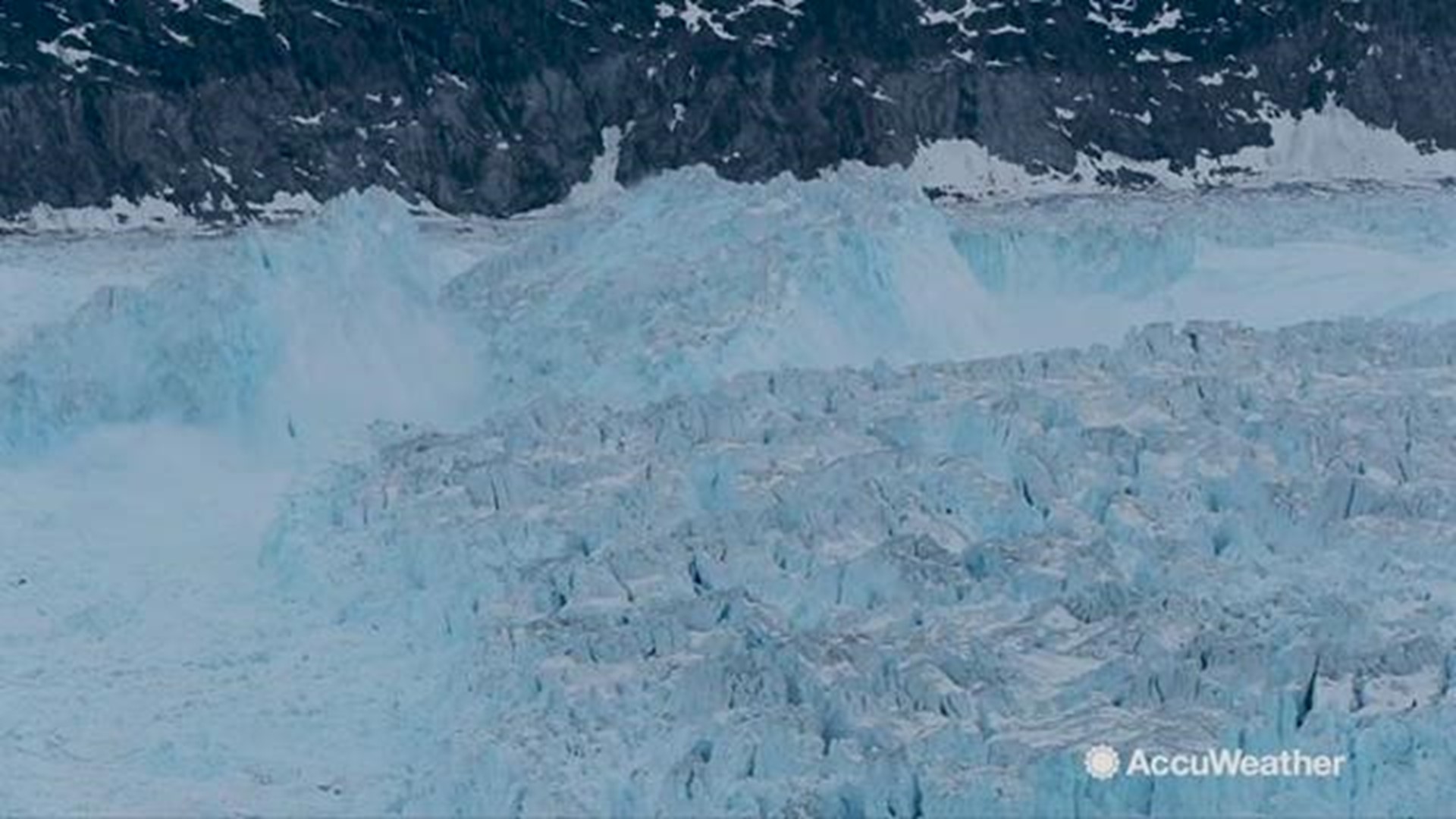 Time-lapse video shows a four-mile wide chunk of ice breaking away from the Helheim Glacier in Tasiilaq, Greenland, a rarely documented event called calving.