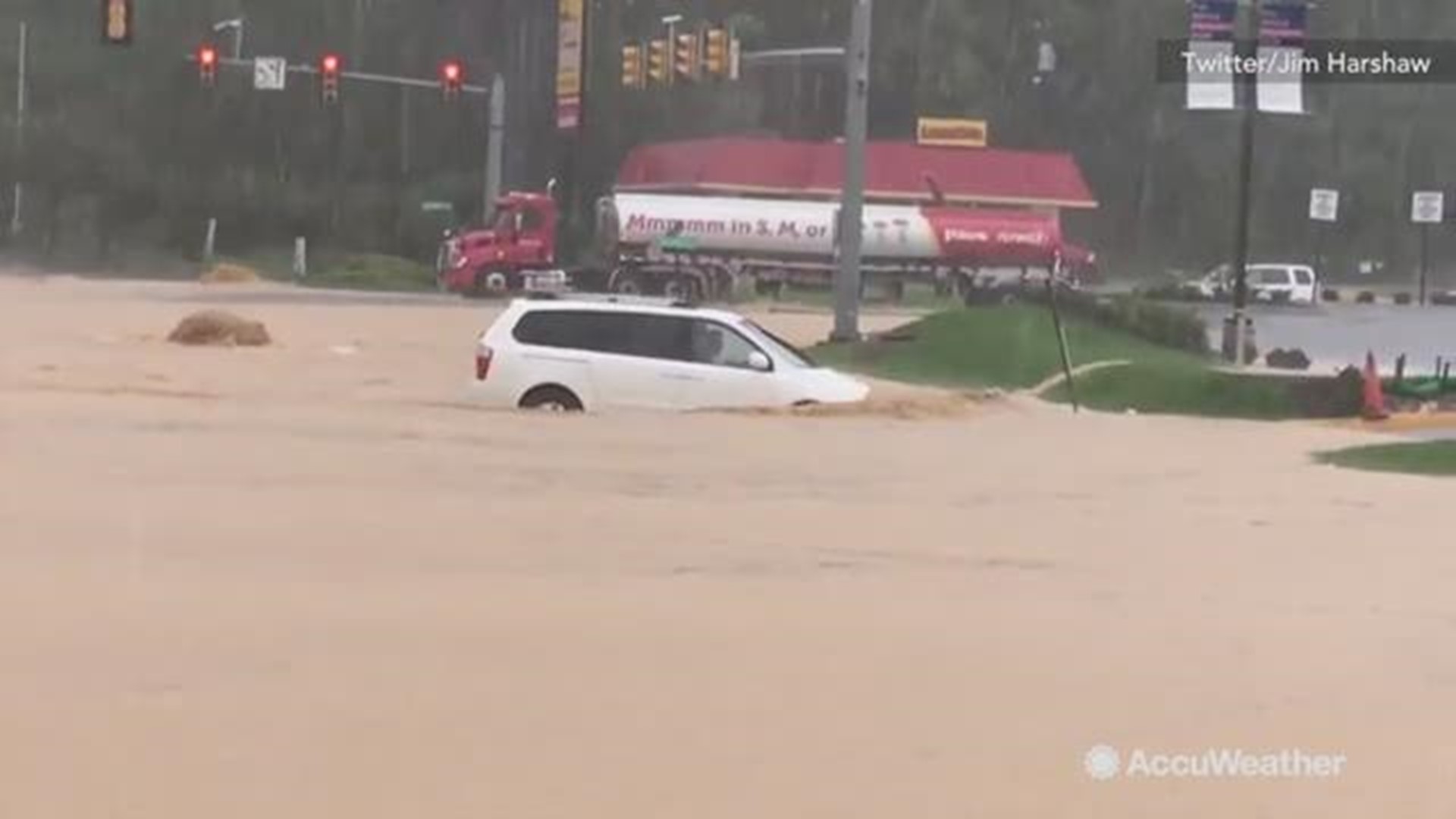 Many vehicles were seen taking a big risk plowing through deep floodwaters in Roanoke, Virginia on October 10.  Some were even trapped.