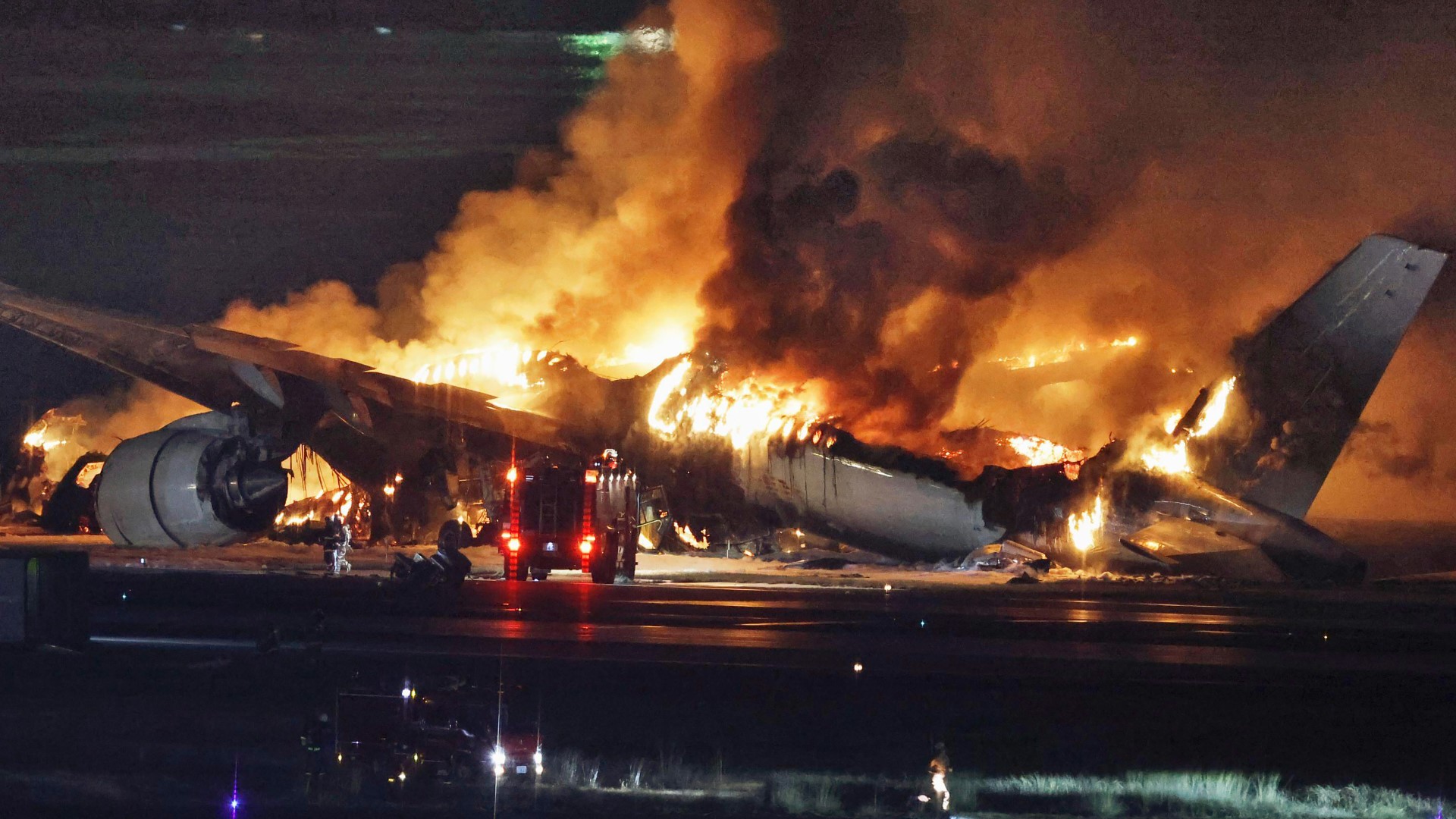 Plane bursts into flames on airport runway in Tokyo