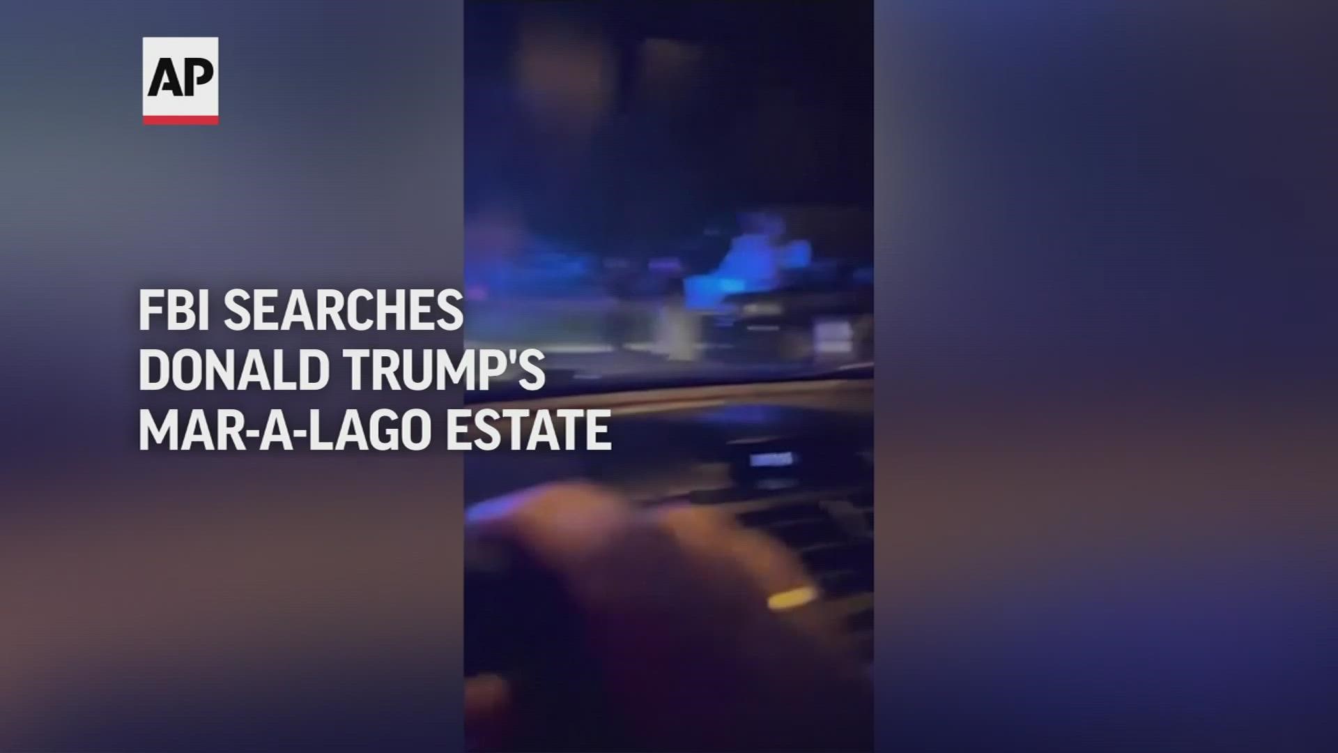 WATCH: Video taken Monday night shows law enforcement outside of the estate. Trump said agents broke into his safe.