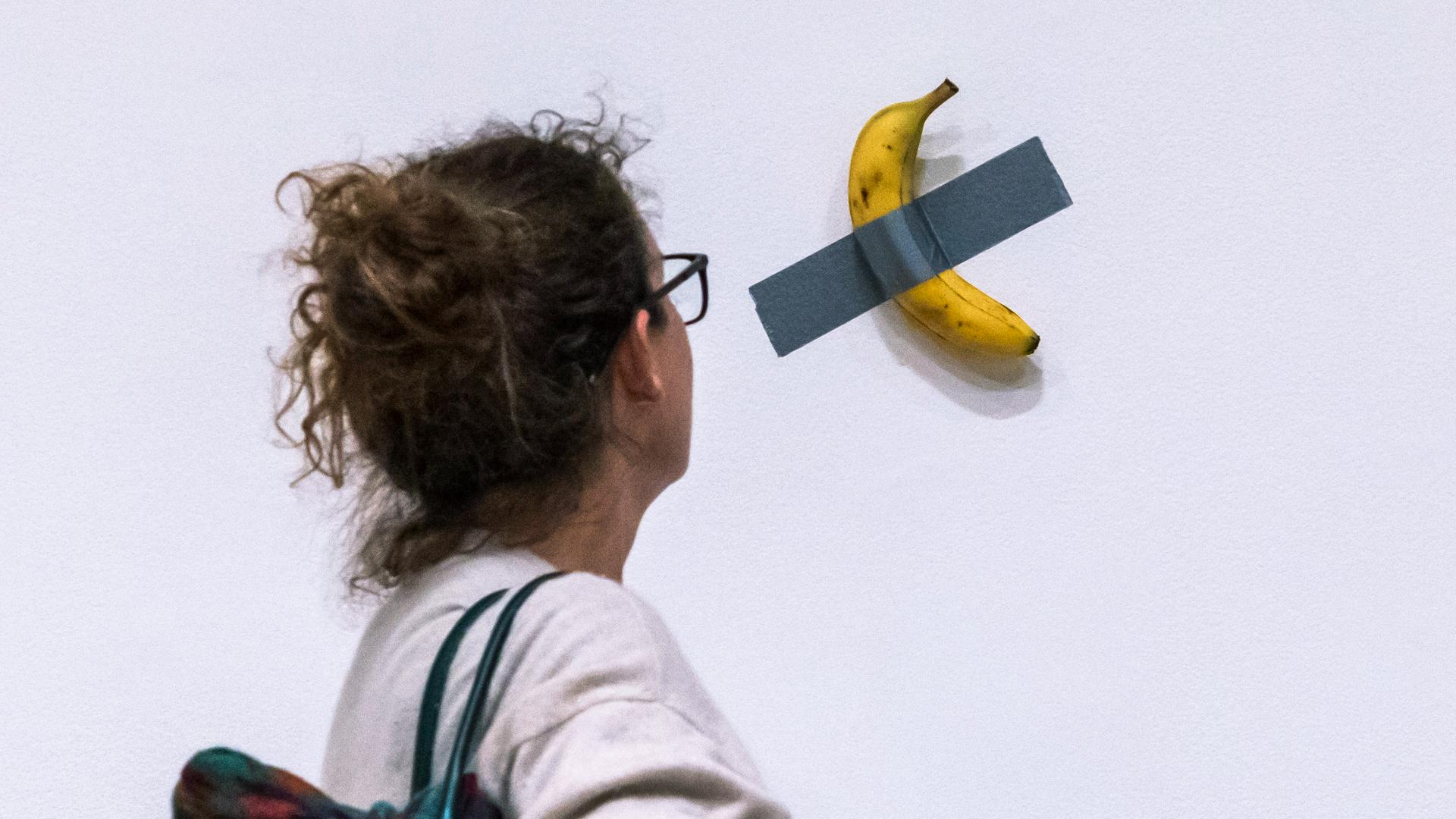 A piece of conceptual art consisting of a banana duct-taped to a wall sold for a total of $6.2 million at an auction in New York on Wednesday.