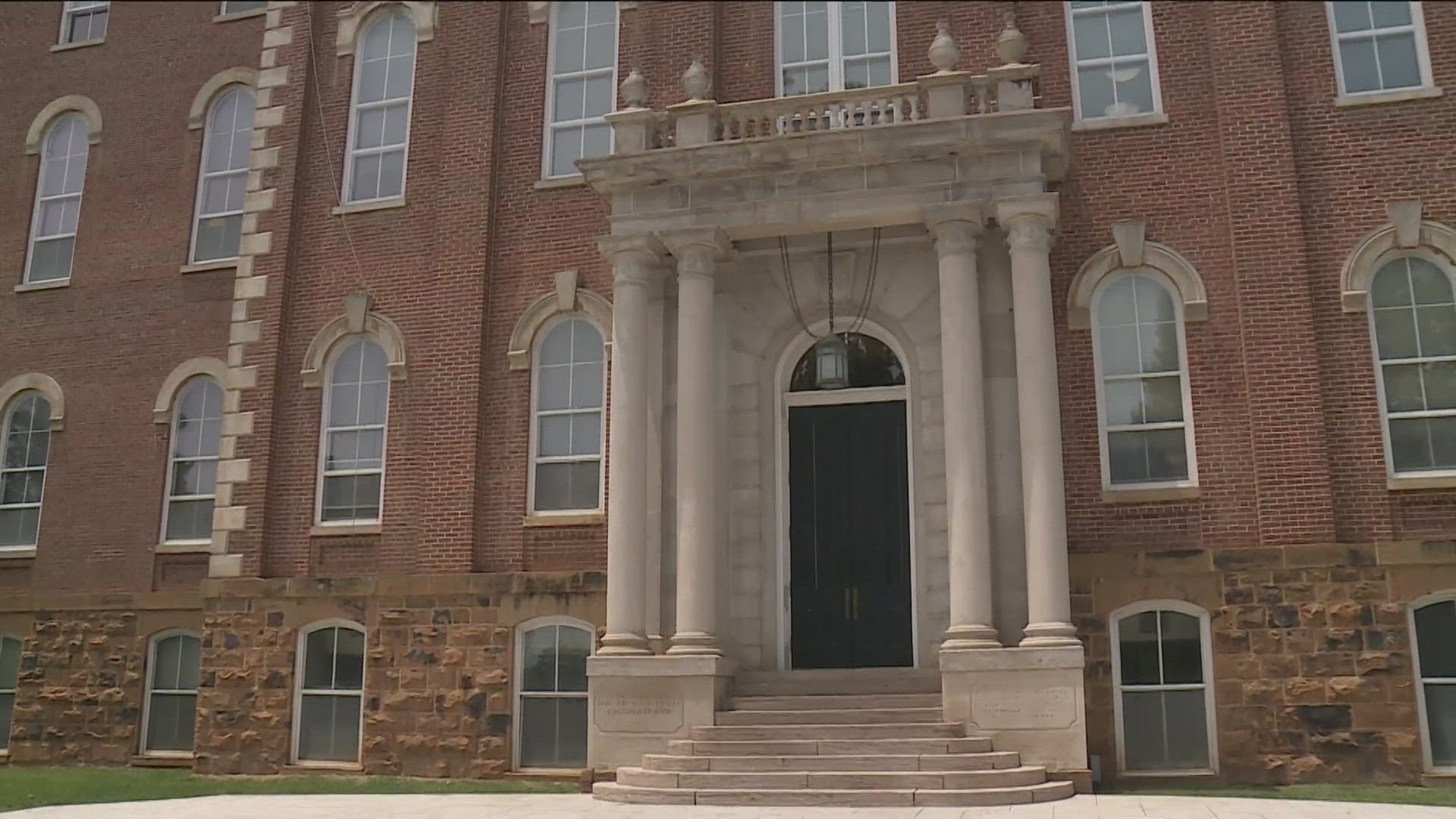 The African and African American Studies Program director says vandals carved a swastika over a sticker, the word "gay" was etched into the door, and more.