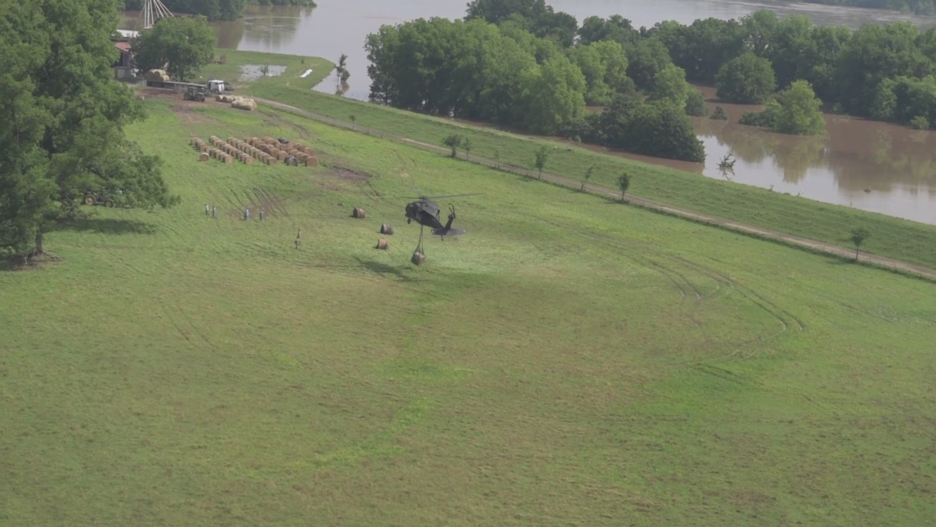 Arkansas National Guard Soldiers with the 77th ECAB assist local farmers in Conway County, Ark., by airlifting hay bales to cattle stranded by floodwaters from the Arkansas River on Tuesday, June 4, 2019