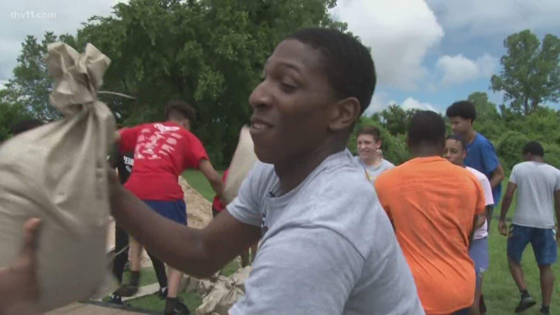 The North Little Rock High School basketball team is helping the community by filling sandbags.