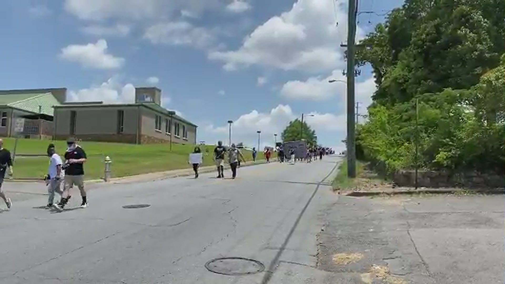 The march makes its way down the 7th Street Hill towards the George Floyd mural in Little Rock.