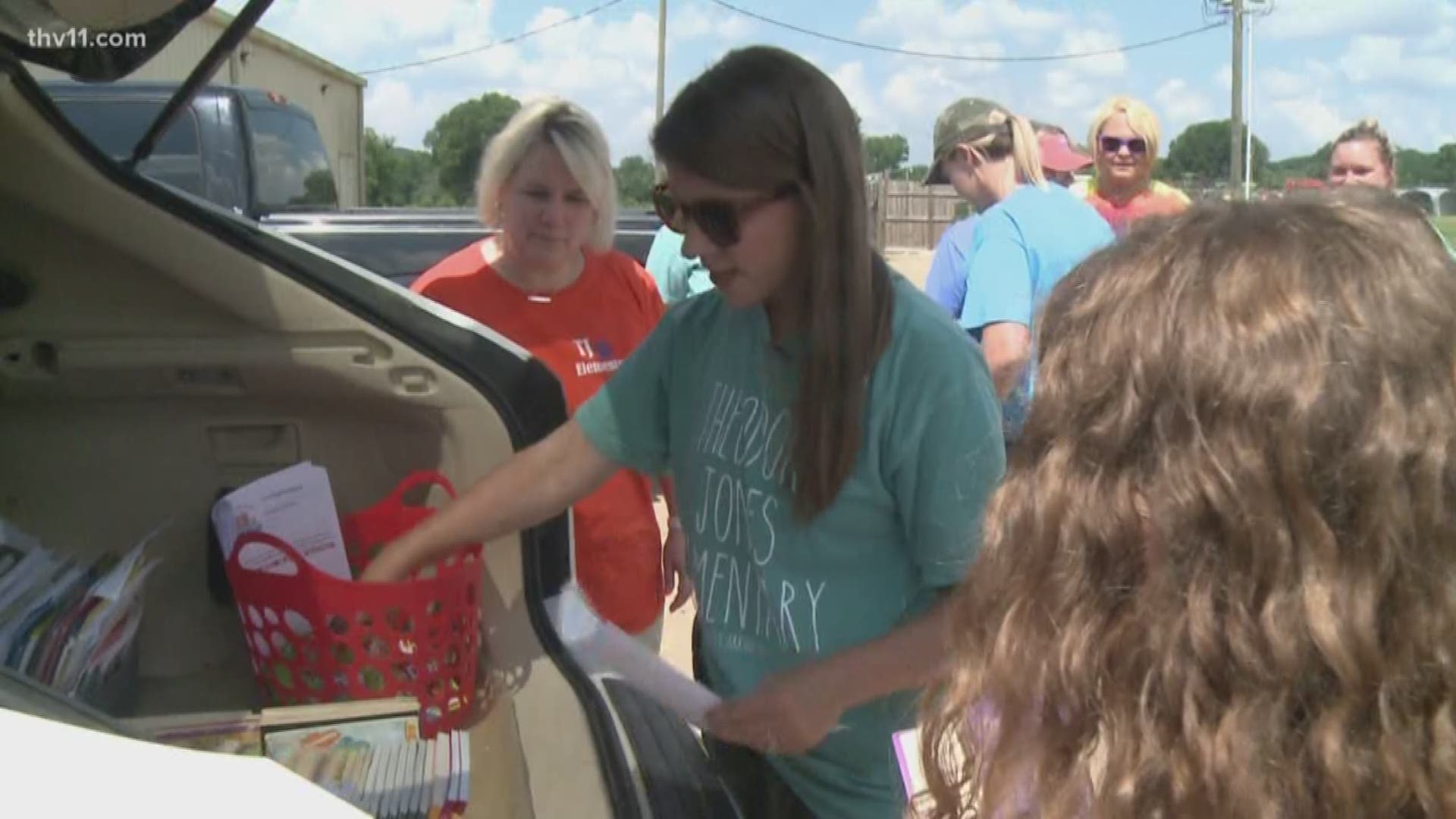 A group of Conway teachers formed a caravan and visiting students' homes with a trunk load of educational gifts.