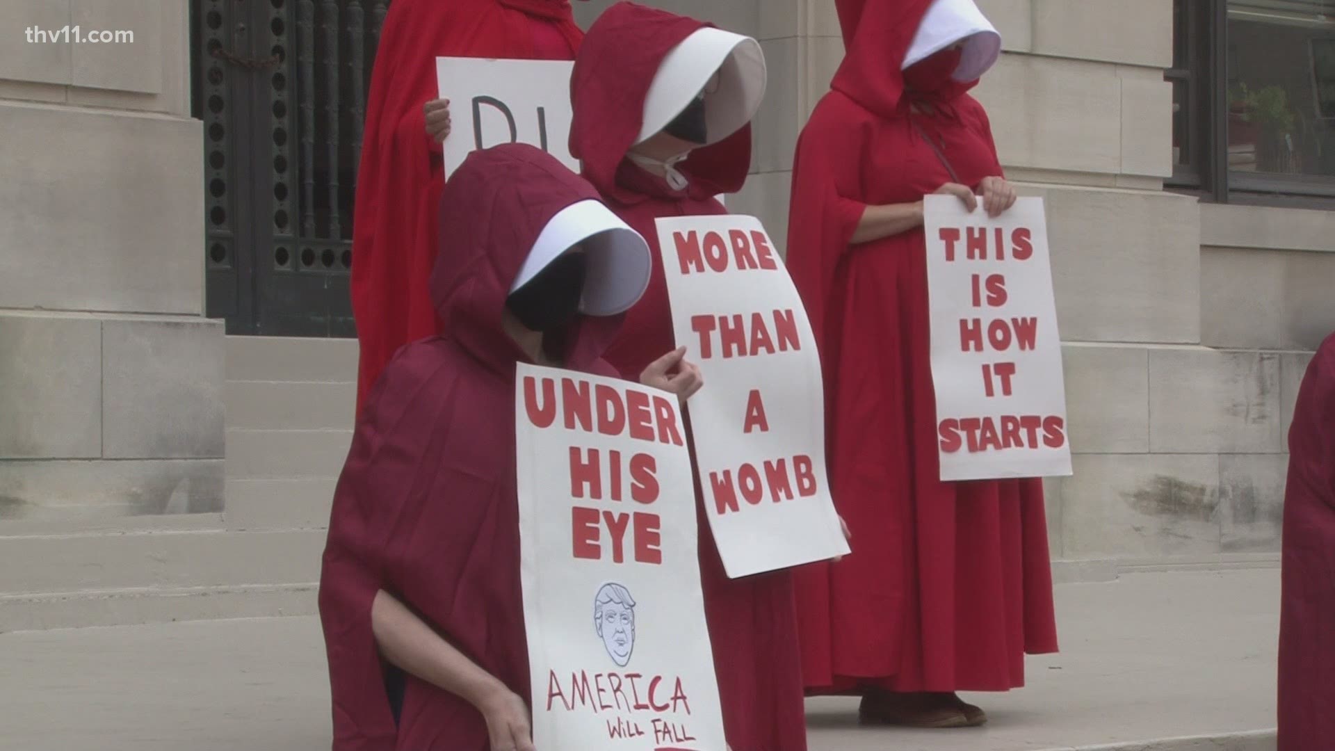Members of the "Red Cloaks" protest group for women's rights held a demonstration outside of the Pulaski County Courthouse.