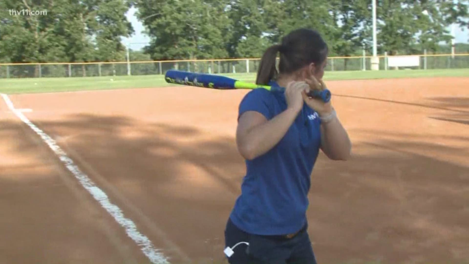 Dorian Craft practices her batting skills before the annual Busch Softball Classic.