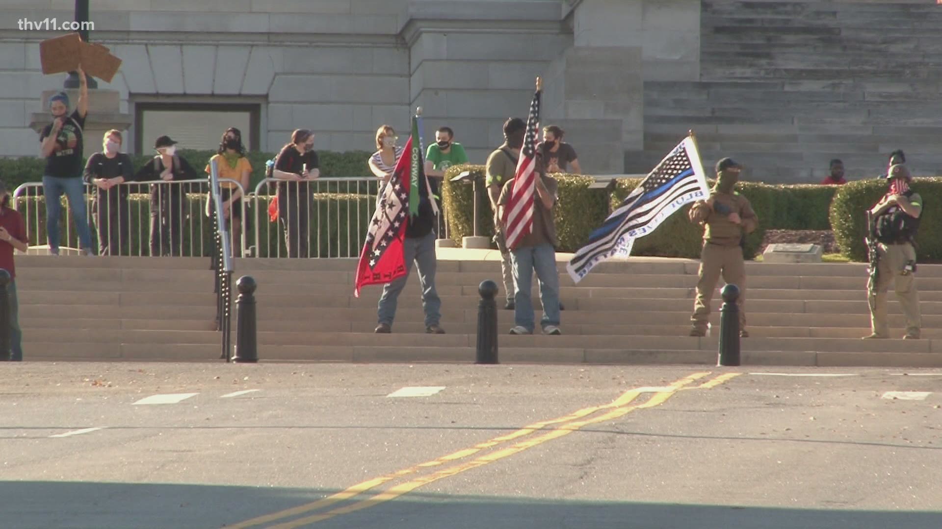 The protesters gathered outside the Capitol building on Saturday afternoon as police monitored the situation.
