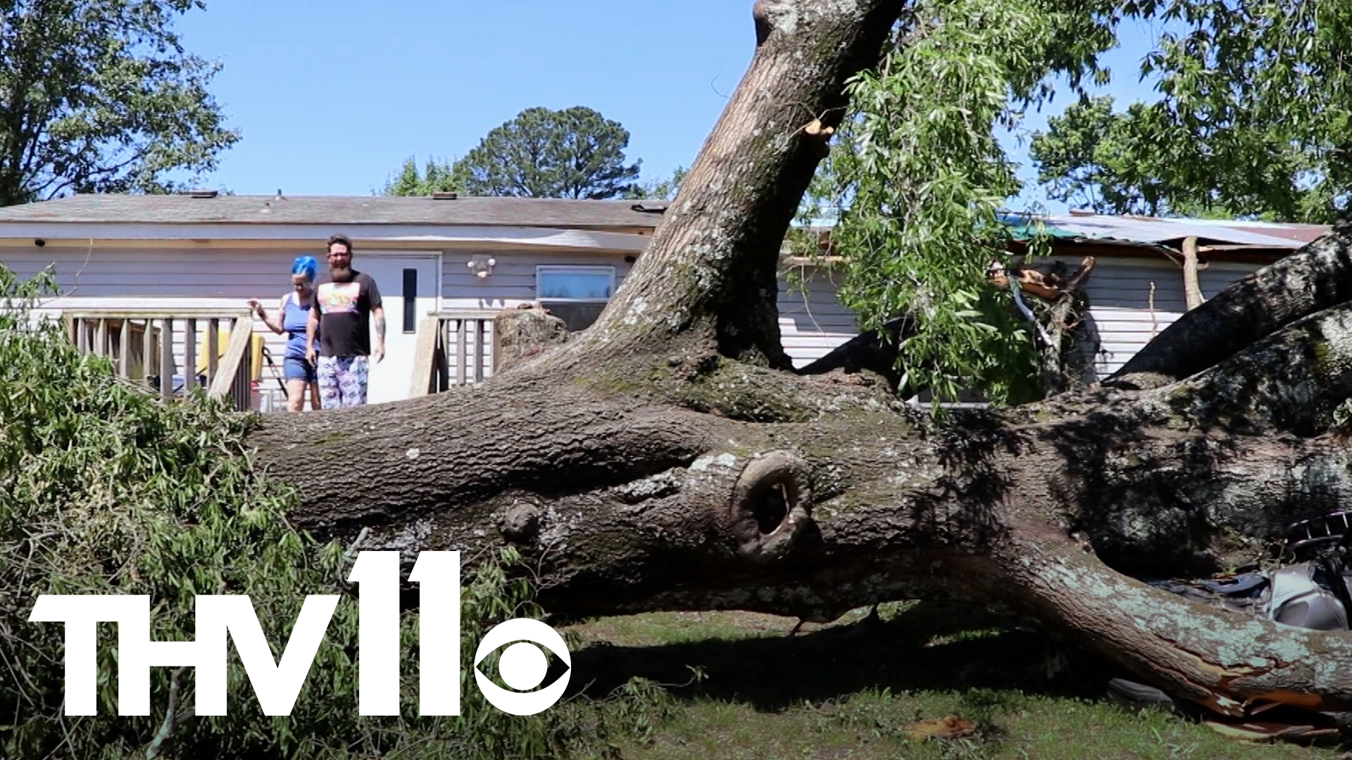 The tornado uprooted dozens of trees in a trailer park near Amity Road in Hot Springs. Although houses and cars were destroyed, neighbors are in good spirits.