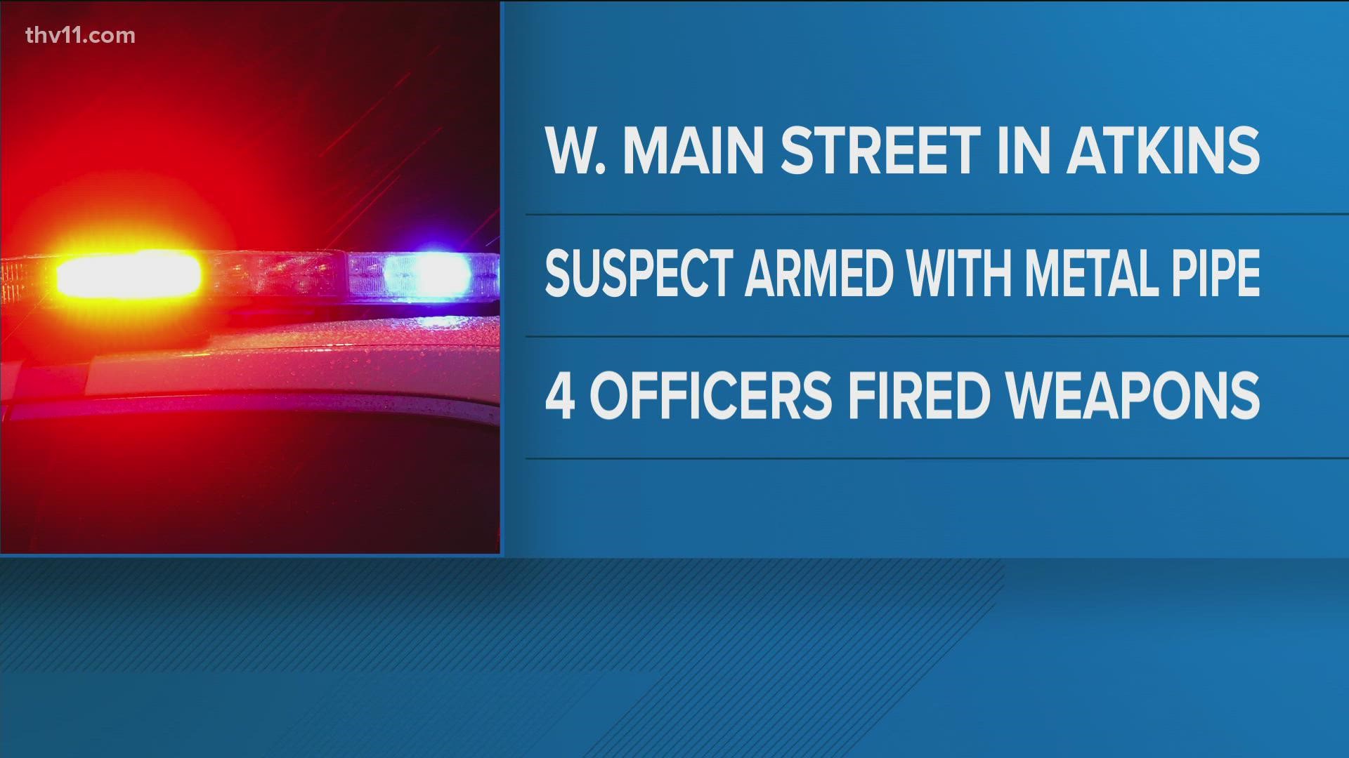 A person died in Atkins after being shot by four law enforcement officers as they allegedly came toward them with a piece of metal pipe.