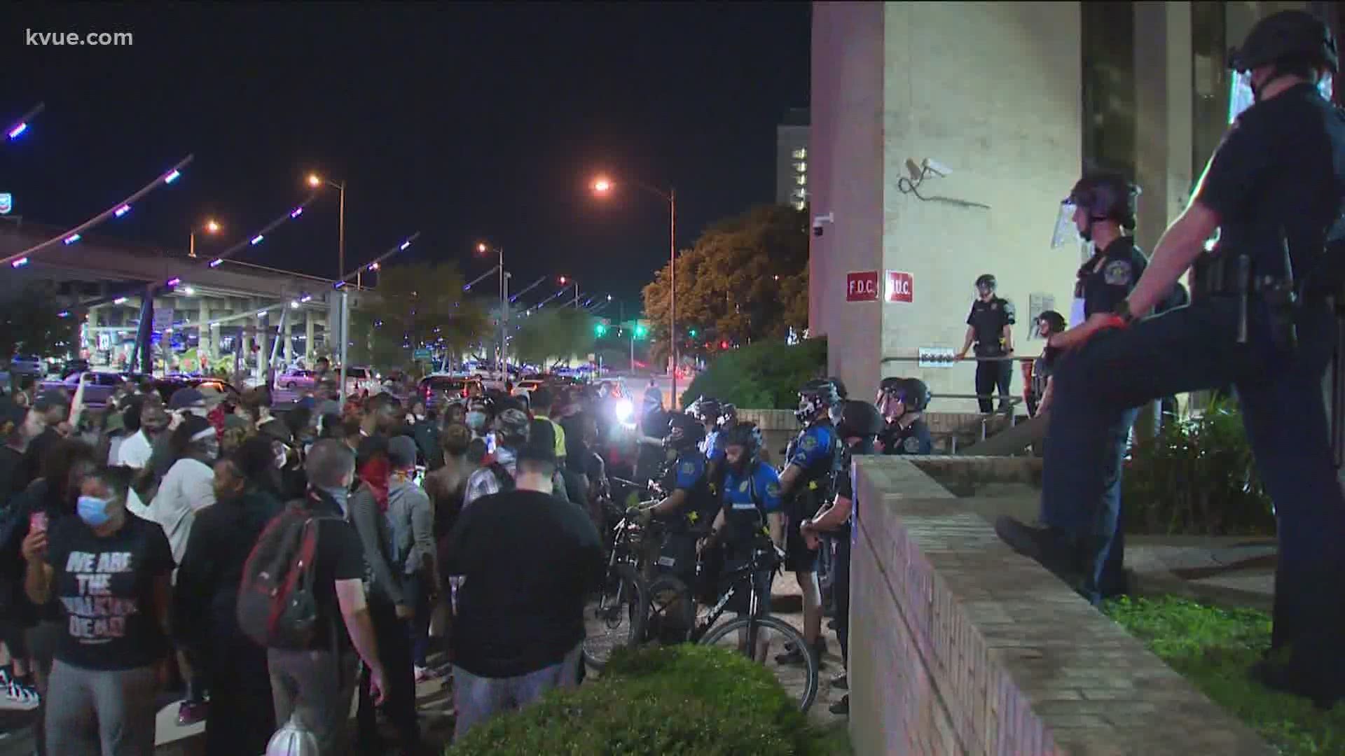 Tensions were high outside the Austin Police Department headquarters Friday night, as people gathered to protests the deaths of George Floyd and Michael Ramos.