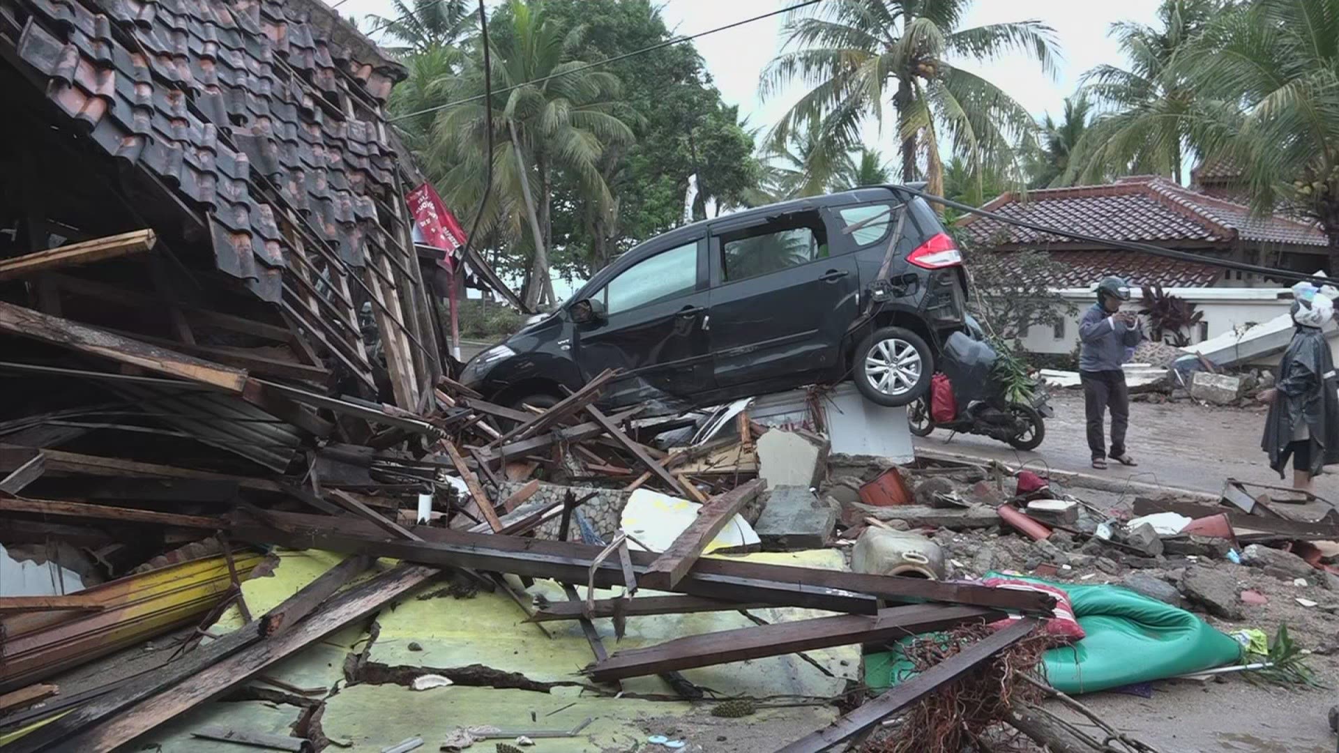 Footage from the Banten province of Indonesia showed widespread tsunami damage to the coastal communities of Carita and Serang, including collapsed houses and cars smashed up on piles of rubble. (AP)