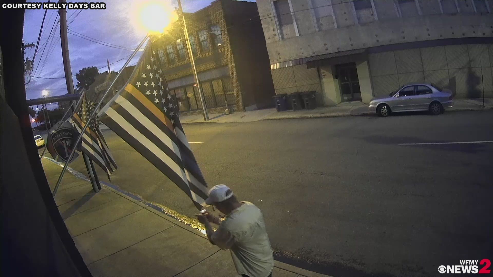 Winston-Salem police are searching for a High Point man they believe tried to burn two American 'Blue Line' flags hanging outside a bar popular among police and first responders.
