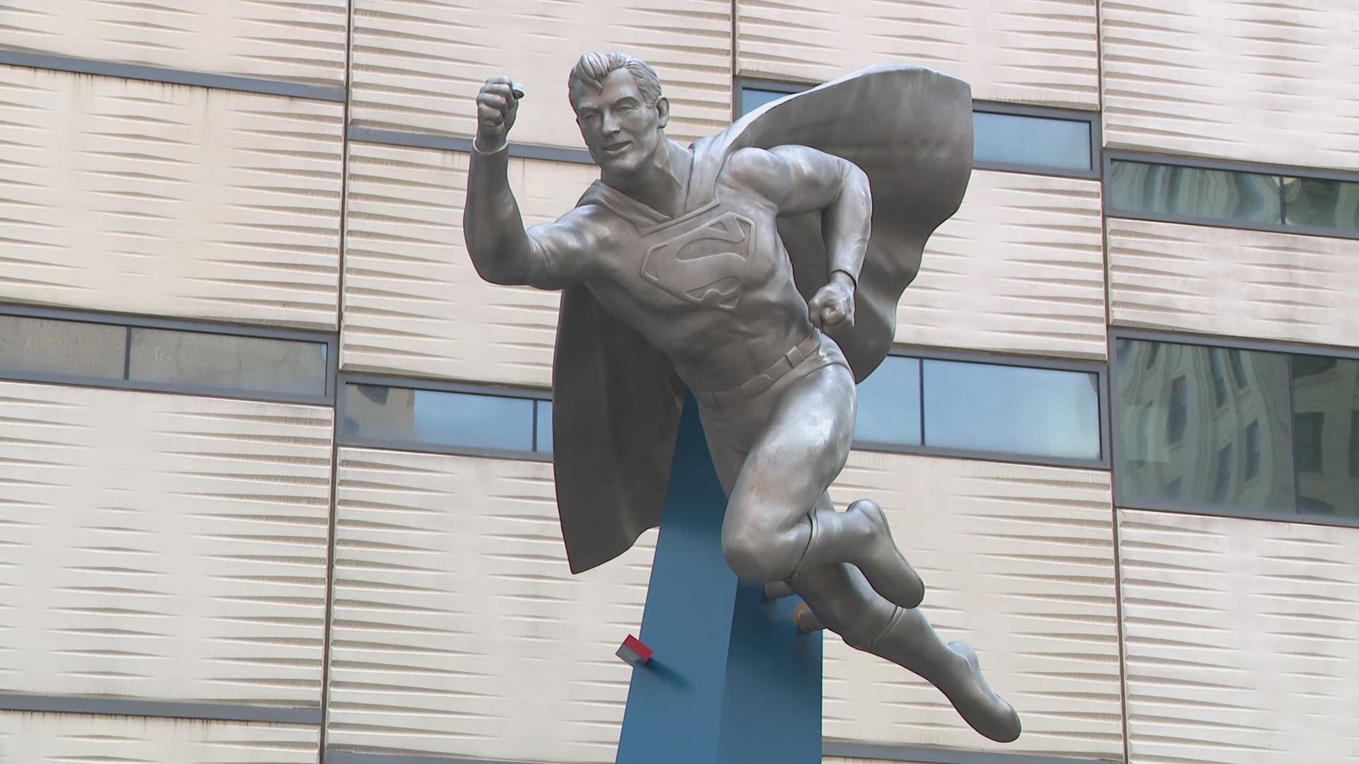 Towering atop an 18-foot pillar, the stainless-steel figure now watches over the city where his story began nearly a century ago.